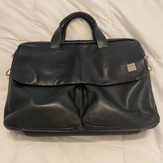 This Is A Used Knomo London Warwick Black Leather Messenger Bag. The Flap That Covers The Two Front Pockets Has A Magnetic Closer, And There Are Multiple Internal Pouches And Zip Pockets To Organize All Of Your Essentials. Padded Main Compartment Fits Laptops Up To At Least 15.5 (I Have One). Besides Having A Few Minor Scuffs (They Do Not Show In Pictures) The Only Sign Of Wear Is On The Handles. Some Of The Outer Layer Of Stitching Has Loosened. The Inner Stitching Is Still Intact. No Strap. Classic Black Soft Leather Laptop Bag, Formal Black Leather Laptop Bag, Leather Shoulder Bag With Removable Pouch For Business Trips, Classic Black Laptop Bag With Removable Pouch, Black Tote Briefcase For Formal Use, Black Tote Satchel For Business Trips, Black Business Laptop Bag With Removable Pouch, Black Leather-backed Briefcase For Business, Business Black Soft Leather Shoulder Bag