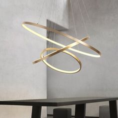 a modern chandelier hanging over a dining room table