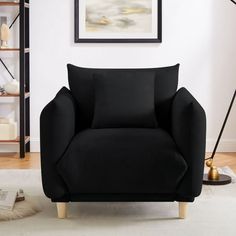 a black chair sitting on top of a white rug