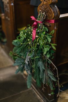 the wedding flowers are tied to the church pews and placed on top of each other