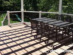 a table and chairs sitting on top of a wooden deck