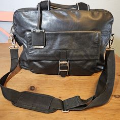 Boss Hugo Boss Weekender/Messenger Style Bag. Approximately 17" X 4" X 12" With 4" Drop Handles And Comes With Adjustable Crossbody/Shoulder Strap. 100% Cow Skin (Buttery Soft Leather), Black With Silver Hardware. Hardware Includes: 2-Way Zip Top Closure, Heavy Bag Tag Charm, Pad Lock With Key To Keep Your Valuable Safe. Double Top Handles With Hugo Boss Branded Bag Tag, Small Side Pocket For Attached Padlock Key, Exterior Flap Pocket & Slip Pocket. Fully Lined Interior With Key Hook, Zip Pocket Hugo Boss Wallet, Pad Lock, Boss Brand, Leather Weekender, Boss Black, Cow Skin, Heavy Bags, Key Hook, Messenger Bag Men