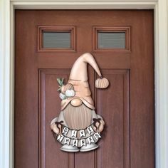 a wooden door with a happy new year gnome sign on it's front porch