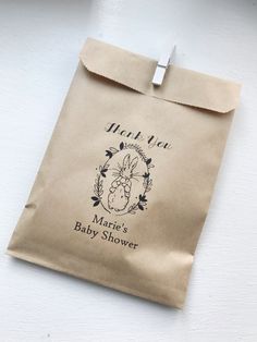 a brown paper bag with the words thank you and a baby's head on it