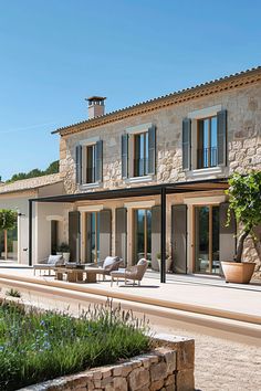 a large stone house with an outdoor seating area