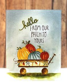 a card with pumpkins in a wheelbarrow and the words hello from our patch to yours