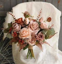 a bouquet of flowers sitting on top of a white chair