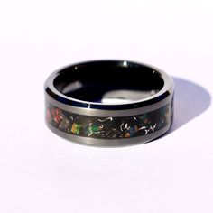 The Eclipse Ring, Handmade Black Ceramic Custom Ring, Black Fire Opal Meteorite Obsidian Inlay Ring, Glow in the Dark Ring for Men & Women This is the Eclipse Ring, made with Black Fire Opal, Obsidian, and Meteorite shavings on a black background and glows blue. The primary color of the Black Fire Opal is Black with constantly shifting colors like hints of purple, red, green, blue and yellow. The Meteorite shavings add contrast to the ring, highlighting the opal as well as the black ceramic Luxury Black Men's Ring With Black Enamel, Luxury Black Enamel Men's Ring As Gift, Luxury Men's Black Enamel Ring, Raw Obsidian, Glow In The Dark Ring, Dark Ring, Lavender Ring, Black Fire Opal, Dark Rings