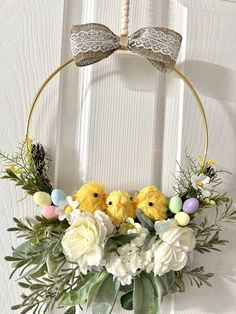 an easter wreath with flowers and chicks on it