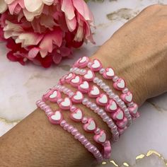 the pink and white bracelets have hearts on them