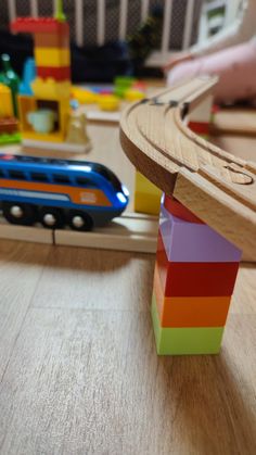 a wooden toy train set with colorful blocks