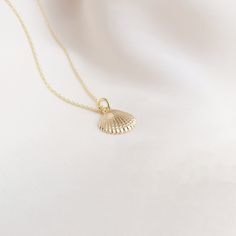 Gold Seashell Necklace Be inspired by our dainty and meaningful seashell necklace. Our gold seashell necklace represents beauty, good fortune and feminine energy. This minimalist necklace comes with an inspirational description card and is packaged in a branded Bohemarie gift box, making this necklace the perfect gift for yourself or a special loved one. Necklace Details: * Seashell Charm: 1.2 x 1.8cm * Chain Length: 40cm, 45cm or 50cm * Chain Style: Dainty Trace Chain or Beaded Satellite Chain * Material: 18k Gold Plated Sterling Silver * Skin Friendly: Hypoallergenic & Nickel-Free More From Us: * www.etsy.com/uk/shop/BohemarieJewellery Gold Seashell Necklace, Gold Shell Necklace, Shell Charm Necklace, Shell Jewellery, Necklace Shell, Seashell Pendants, Jewellery Necklaces, Gold Necklace Simple, Seashell Jewelry