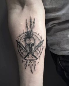 a man's arm with a tattoo on it and two crossed swords in the middle