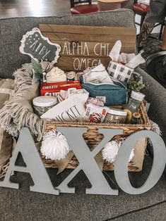 a basket filled with personal items sitting on top of a couch next to a sign