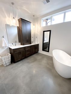 a large white bath tub sitting inside of a bathroom