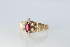 Wonderful ring, very rare to find. 10k Yellow gold. Hallmarked and tests appropriately.  Oval Ruby and Diamond Halo on a ribbed shank. Condition: Has not been polished. Shows minimal signs of wear. Details: 3mm by 6mm marquise Ruby 1mm diamonds 10.5mm widest point on shank 2.5grams total 10k Yellow Gold Size 7.25 Diamond Halo Ring, Halo Diamond Ring, Halo Ring, Halo Rings, Diamond Halo, Halo Diamond, Halloween Shopping, Halo, Ruby