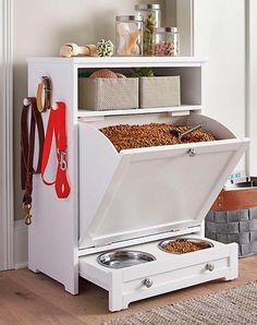 a white cabinet with drawers and two bowls in it next to a rug on the floor