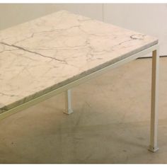 a white marble table sitting on top of a hard wood floor