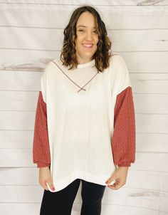 Let's celebrate the start of summer with a top that's just plain gorgeous. A cross between a top, a crewneck pullover, and a sweater, this top is made of the SOFTEST fabric ever and has a fun color-block look with the cable-knit sleeves. You're going to want to wear this every day. The fabric is incredibly lightweight (and oversized) making this the perfect top for summer evenings, whether you're heading out to dinner, to a brewery, or for a post-sunset beach stroll. Plus, this top will be styli White Raglan Sleeve Top For Fall, Casual Color Block Tops For Loungewear, Fall Color Block Top With Raglan Sleeves, Spring Crew Neck Long Sleeve Top With Textured Knit, Spring Color Block Crew Neck Sweatshirt, Color Block Crew Neck Sweater For Loungewear, Spring Textured Knit Long Sleeve Crew Neck Top, Red Sweater For Spring Loungewear, Soft Knit Relaxed Fit Tops For Day Out