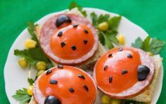 some food is on a white plate with green and yellow leaves around it as if they were ladybugs