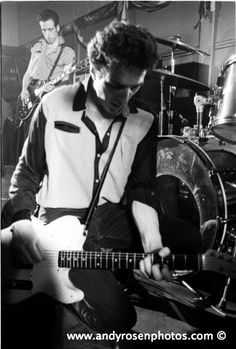 black and white photograph of man playing guitar