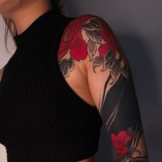 a woman with tattoos on her arm and shoulder