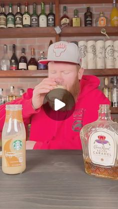 a man sitting at a bar drinking from a bottle