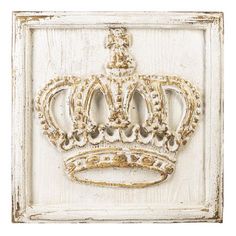 an old white frame with a gold crown on it