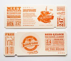 two tickets with orange and white designs on the front, one is for beer company