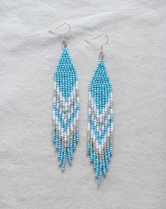 Fringe Earrings made with blue white and silver seed beads and finished with a hypoallergenic nickel free hook. *All of my materials used for my pieces are purchased from other local small indigenous businesses. it's very important to me to keep what I make local and in support of other small businesses and my indigenous communities.** If you love your items once received, I'd appreciate so much if you could leave a review in my shop! :-) This is tremendously helpful for any small business to gr Indigenous Earrings, Beaded Fringe Earrings, Winter Blue, Indigenous Community, Winter Blues, Love Your, Bead Work