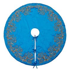 a blue and silver round table cover with floral designs on the edges, sitting on a white surface