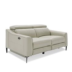 a white leather couch with two reclinings on the back and one arm facing forward