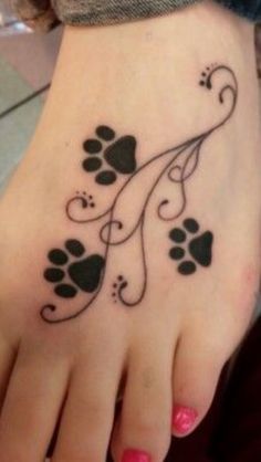 a woman's foot with an animal paw tattoo on it