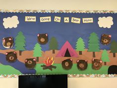 a bulletin board with bears and campfire on it