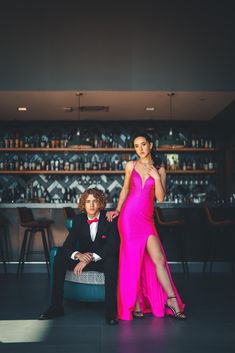 a man sitting next to a woman in a pink dress