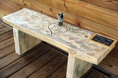 a wooden bench with writing on it