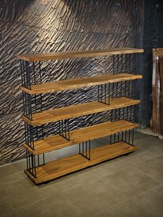 a wooden shelf sitting in front of a wall with metal bars on it's sides