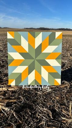 a patchwork quilt in the middle of a field