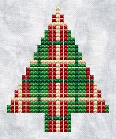 a cross stitch christmas tree with red and green blocks in the shape of an x