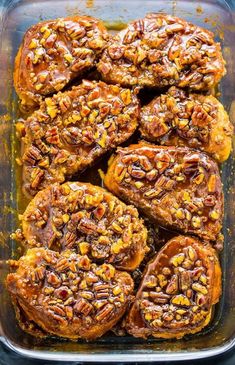 baked pecanized sweet potatoes in a casserole dish with walnuts on top