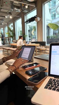 a person sitting at a table with a laptop