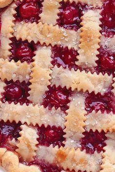 a close up of a pie with cherries on it's crust and toppings