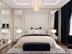 a large white bed sitting under a chandelier in a bedroom