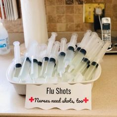 a tray filled with lots of medical tubes next to a cell phone on top of a counter