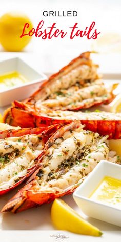 grilled lobster tails on a plate with lemon wedges and sauce in small bowls