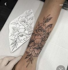 a woman's arm with flowers on it