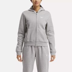 Zip up in this women's Reebok sweatshirt and show off sporty style wherever you go. The cotton-blend fleece feels soft and comfy as a layer, or all on its own. The ribbed cuffs and hem give a cozy, stay-put fit as you move Fleece Hooded Sweatshirt For Jogging, Sporty Fleece Sweats In Athletic Heather, Sporty Athletic Heather Fleece Sweats, Fleece Sweats With Drawstring Hood For Jogging, Fall Fleece Sweatshirt For Jogging, Sportswear Fleece Sweats With Double-lined Hood, Sporty Fleece Jacket With Cozy Fit, Sporty Cozy Fit Fleece Jacket, Heather Hooded Fleece Activewear