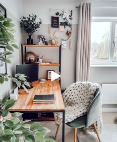 a living room filled with furniture and a wooden table next to a window covered in plants