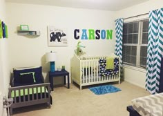 a baby's room decorated in blue, green and white with cribs