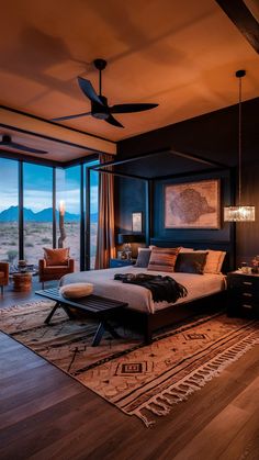 a bedroom with a large bed sitting on top of a wooden floor next to a window